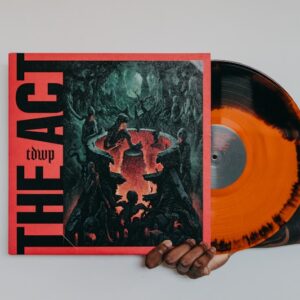 a hand holding an orange and black vinyl album